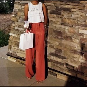 Flaring formal orange pants.